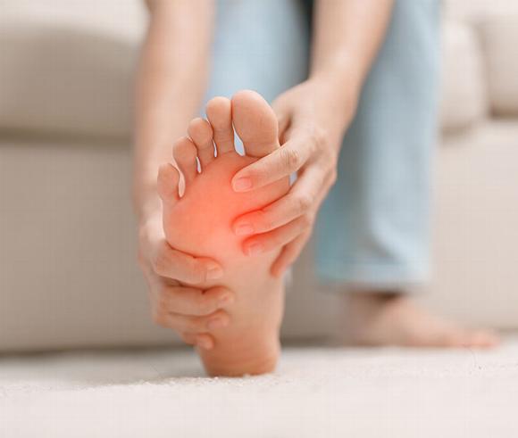 lady touching foot with red hue indicating pain areas