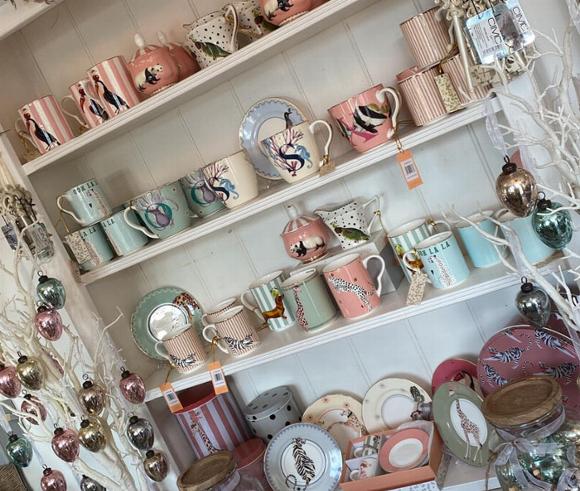 Cups, plates and tea sets in white display case