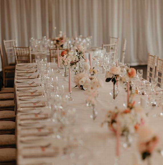 wedding table set up with pink and white flowers